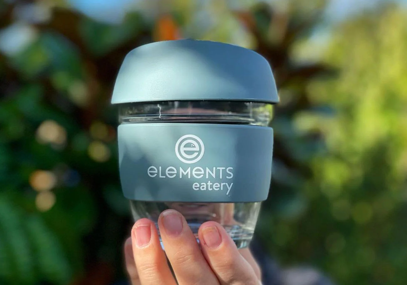 elements eatery logo displayed on a reusable coffee cup